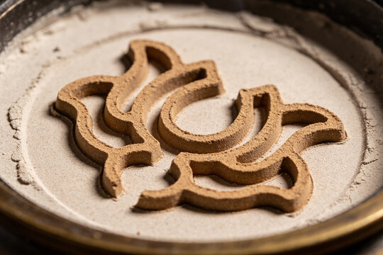 Geometric pattern pressed into fine ash with metal mould