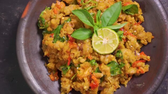 Zoom in view of traditional Indonesian sambal tempe in a mortar