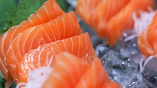 Fresh salmon sashimi sliced into delicate pieces, showcasing vibrant color, smooth texture and premium seafood quality in a classic Japanese presentation.