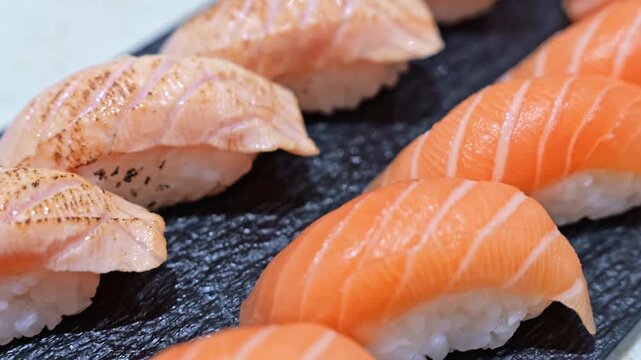 Fresh salmon sashimi sliced into delicate pieces, showcasing vibrant color, smooth texture and premium seafood quality in a classic Japanese presentation.
