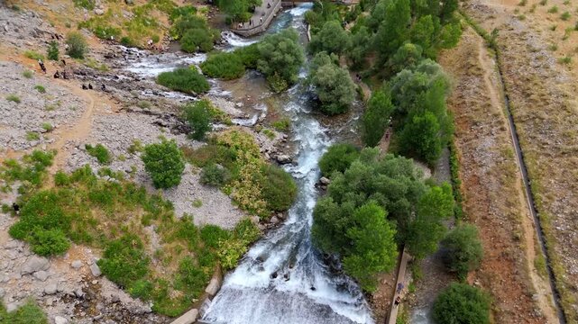 Rugged terrain flows with a clear, rushing stream (Munzur Gozeleri Ovacik Tunceli)