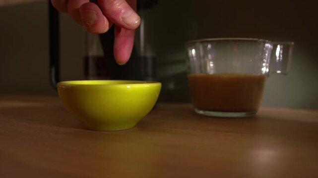 Hand leaves cash tips for service in bowl medium slow motion zoom shot selective focus