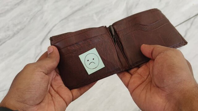 Poor or broke Asian person hands opening empty wallet with worried sad face. Financial crisis, debt, bankruptcy, unemployment, recession, poverty, no money, inflation and emergency crisis concept.