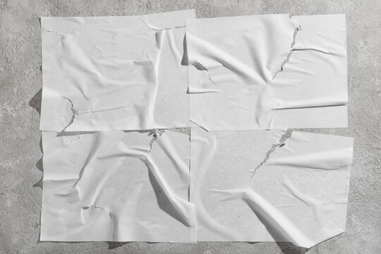 Urban street art mockup, blank torn paper posters on concrete wall for advertising and graphic design branding template with wrinkled texture and folds