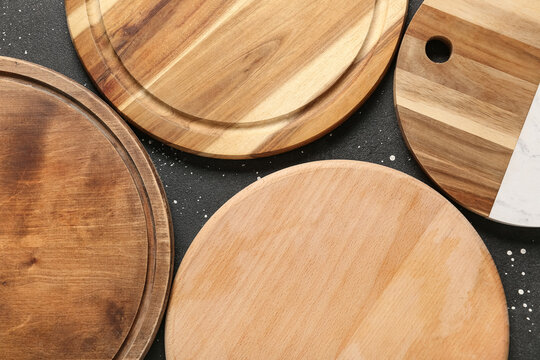 Food preparation and culinary presentation, round wooden cutting boards on dark textured background for kitchen cooking and restaurant menu design