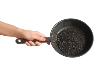 Cooking failure and kitchen accident, hand holding a burnt frying pan with charred food residue for...