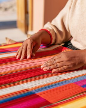 Hand weaving colorful textile with vibrant striped pattern