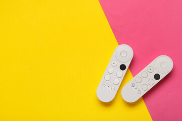 TV remote controllers on color background © Pixel-Shot