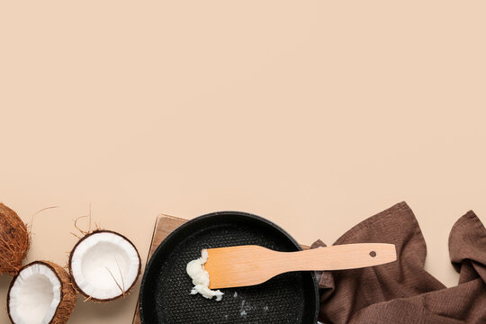 Frying pan with coconut butter on beige background