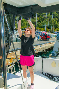 Woman sitting on bow of the yacht during sailing