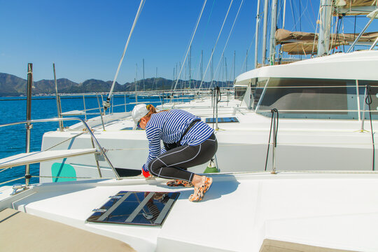 Woman sitting on bow of the yacht during sailing