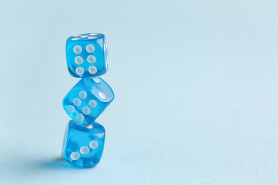 Stack of blue game dices on color background