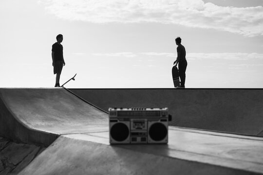 Young people having fun at skateboard park outdoor - Extreme sport concept - Main focus on people bodies - Black and white editing - UGC content