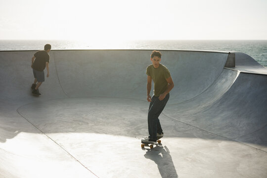 Young people having fun at skateboard park outdoor - Summer lifestyle and extreme sport concept - Main focus on right guy face - UGC content