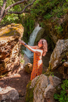 Travel Woman happy in a park spring near water