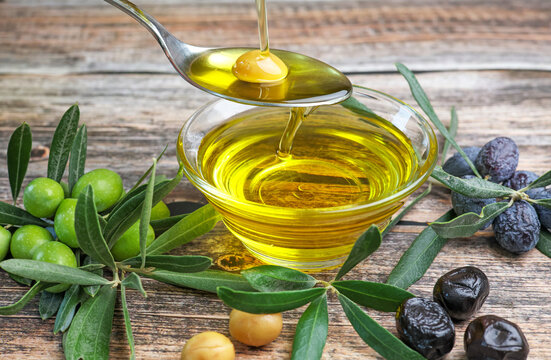 organic olive oil pouring in a glass bowl	