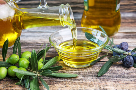 Organic olive oil pouring in a glass bowl	