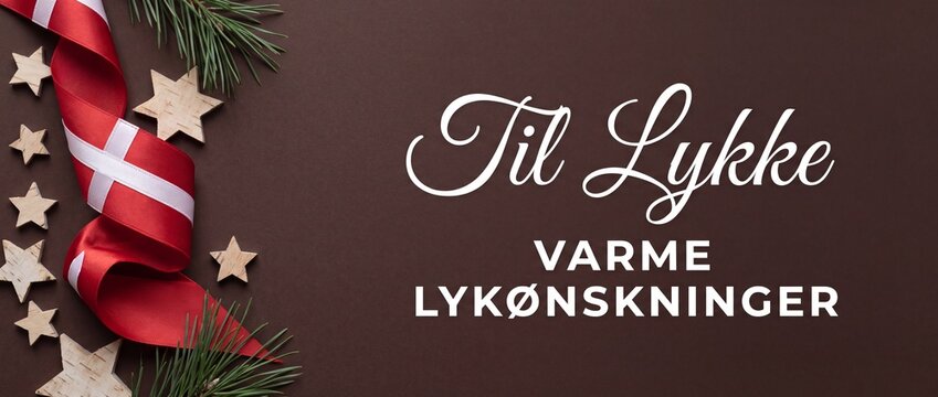 Danish Christmas congratulations greeting card background with Dannebrog ribbon, wooden stars, pine branches on dark brown wood for Nordic holiday, birthday celebration, and festive warm wishes banner