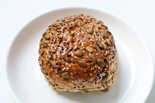 Healthy multigrain bread bun topped with mixed seeds and grains