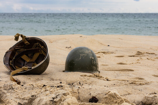 Two American infantry helmets from World War II on the beach