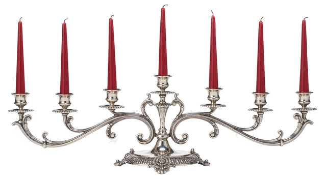 Ornate silver candelabra holding seven red taper candles, isolated on transparent background