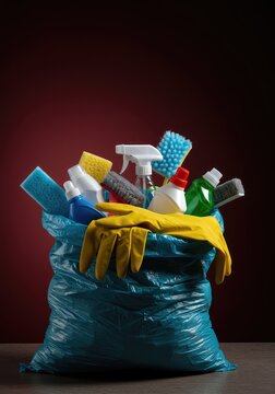 Household cleaning supplies being crammed into a disposal sack, symbolizing the end of boring daily chores and tasks and newfound relief ,chores ,tools ,responsibility