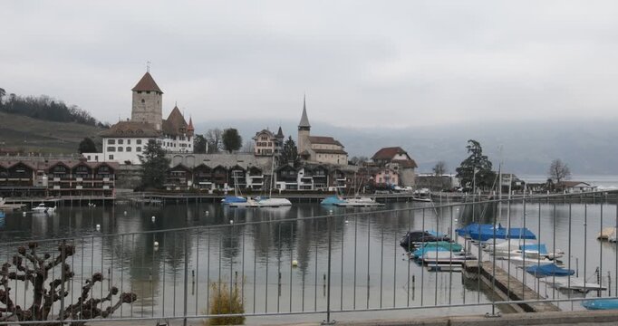 Spiez Castle and Marina on Lake Thun, Switzerland,overlooking the marina and calm waters of Lake Thun in Spiez, Switzerland. Historic architecture, sailboats and reflections create a picturesque lakes