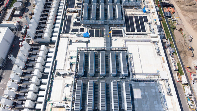 Aerial view of the Equinix Data Center featuring rows of industrial cooling units and server infrastructure on a modern facility roof in Castelletto, Lombardia, Italy.