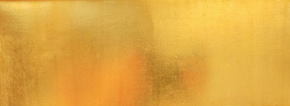 Gold texture background with yellow foil luxury shiny shine glitter sparkle of bright light reflection on golden surface, for celebration backdrop, wallpaper, Christmas decoration banner, horizontal