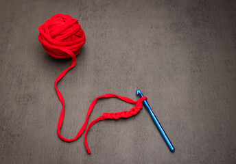 Hands crocheting with yarn, crafting process in action.
