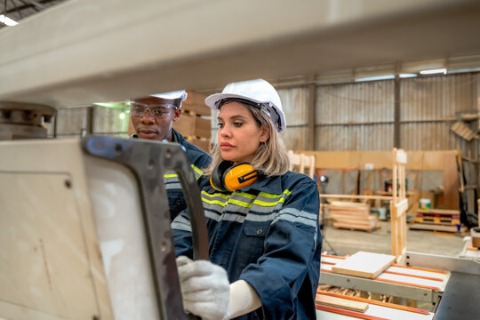 Diverse engineering team collaborates set precise specifications for timber board thickness before production highlights smart factory technology, timber processing, and manufacturing engineering 