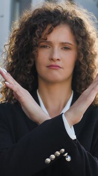 Portrait Caucasian serious confident business woman crossing hands never no protest gesture girl female businesswoman agent cross arms showing stop reject denied looking at camera in city near office