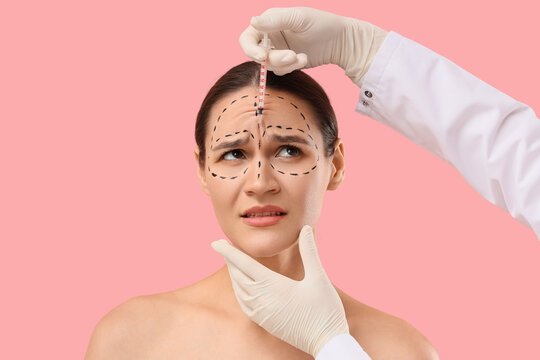 Cosmetic surgery and anti-aging treatment, woman with facial markings receiving botox injection from doctor for wrinkle reduction and skin rejuvenation