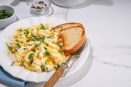 Traditional breakfast scrambled eggs with toasted bread