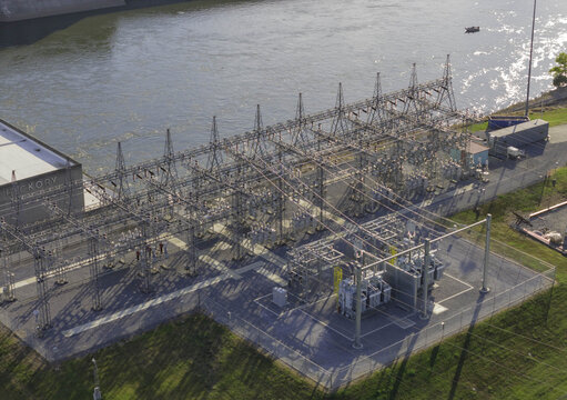 Aerial view of high voltage electrical switchyard with metal structures, transformers, and power lines located next to a river in Hendersonville, Tennessee, United States.