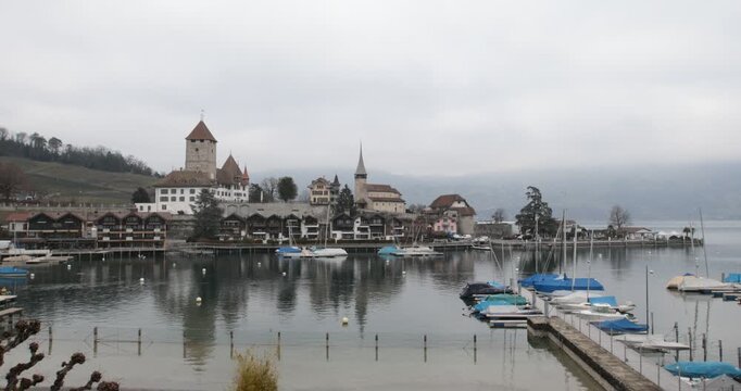 Spiez Castle and Marina on Lake Thun, Switzerland,overlooking the marina and calm waters of Lake Thun in Spiez, Switzerland. Historic architecture, sailboats and reflections create a picturesque lakes