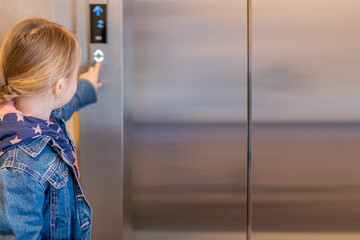little girl pressing elevator button, indoor building scene, everyday action, safety concern, risk strangers, childhood independence, modern urban lifestyle, technology interaction, routine moment © kittyfly