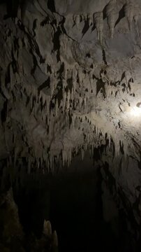 Intricate Stalactites Adorn the Dark Ceiling of a Natural Cave in Prachuap Khiri Khan, Thailand