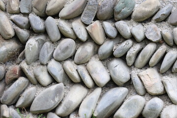 Obraz premium Close Up Texture of Traditional River Pebble Stone Wall Masonry in Mtskheta, Georgia