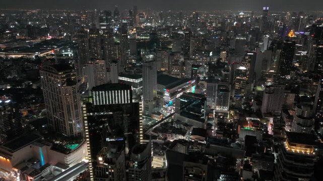 Sparkling city lights of Bangkok shine across the vast urban landscape under the dark velvet night sky showing busy skyscrapers and modern architecture. Thailand 26 april 2026