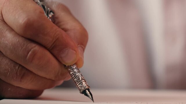 Close up male hand holding pen writing on paper unrecognizable author writer write story handwrite unknown old elderly business man arm aged professor businessman executive script manuscript noting