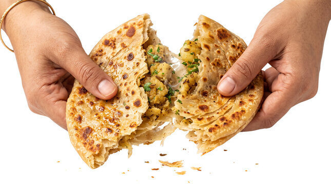 Aloo Paratha stuffed flatbread being torn by hands. Traditional Indian potato paratha with spicy vegetable filling. Golden brown flaky roti. isolated PNG with Transparent Background