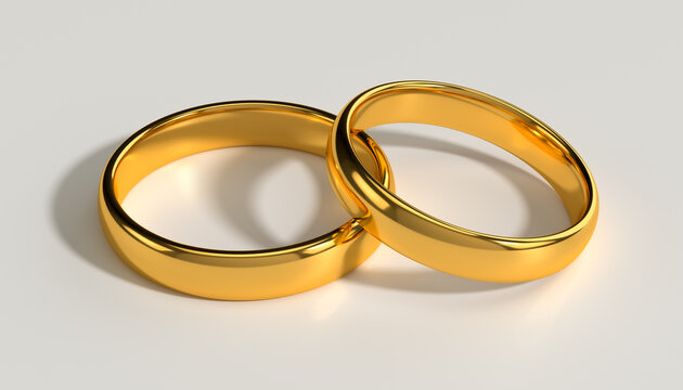 Two connected golden wedding rings as a symbol of love partnership and wedding