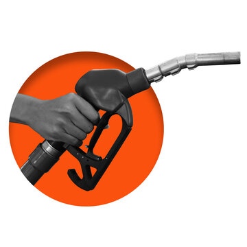 A hand holds a fuel pump nozzle as it is positioned for refueling a vehicle. The setting implies a gas station during daytime.