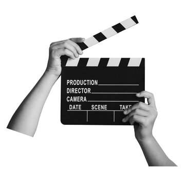 Hands hold a clapperboard with blank sections for production details. This moment represents the start of a filming session in a studio.