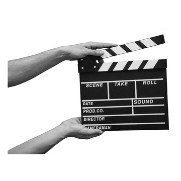 A person holds a film clapperboard with both hands, getting ready to start filming a scene. The clapperboard displays traditional markings for scene, take, and other details.