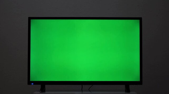 Laptop computer screen with green screen chroma key display, blank mockup monitor for website and app presentation, modern notebook on desk in home office, technology business template footage
