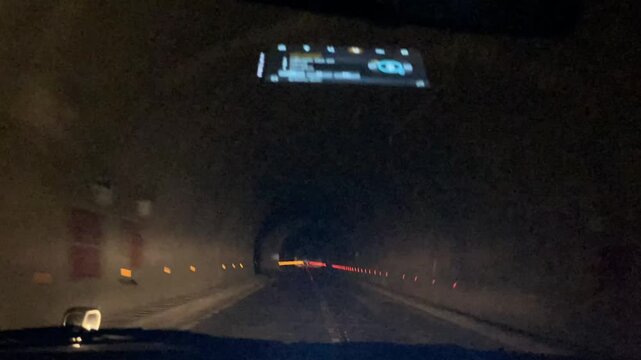 Driving Through Mountain Tunnel Timelapse from Front Windshield View