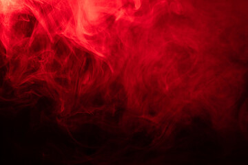 Red smoke effect on a dark background as a Halloween backdrop © ketrin