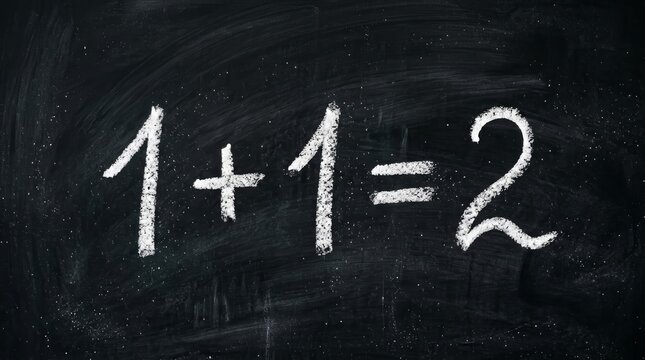 Handwritten simple addition equation 1+1=2 on a chalkboard.
